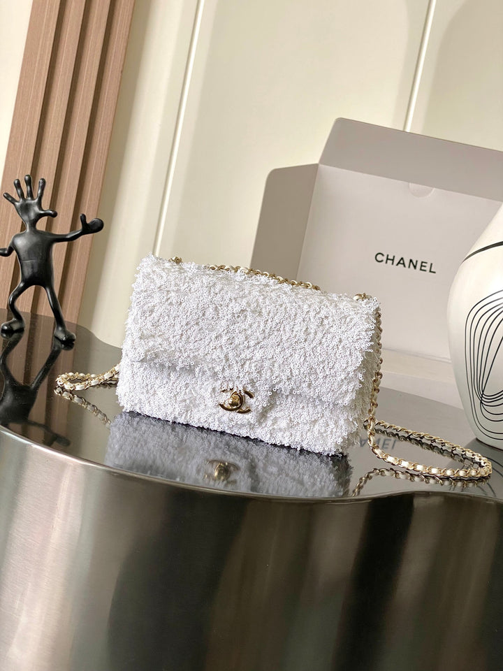 شنطة شانيل فلاب بتفاصيل سلسلة ذهبية انيقة تضيف بريقا خاصا يتناغم مع تطريز الترتر اللامع.